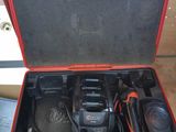 a tool kit in a red case on the floor