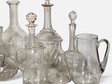 a lot of glass vases that are sitting on a table