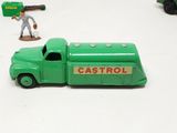 a green toy truck with a gun on the back of it