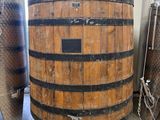 a large wooden barrel sitting in the middle of a room