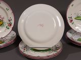 three white plates with colorful designs on them are sitting on a table
