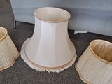 three lamps that are sitting on the floor next to a couch