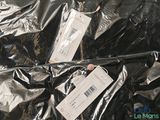a pile of clothes with tags on them on a table