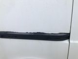 a close up of a white van door with a black handle