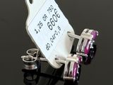a tag that is attached to a pair of earrings on a table