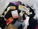 a pile of clothes and other items in a box