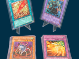 four different types of pokemon cards are displayed on a stand