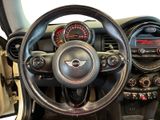 a steering wheel and dashboard of a mini cooper