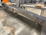 an image of a conveyor belt in a factory with boxes on it