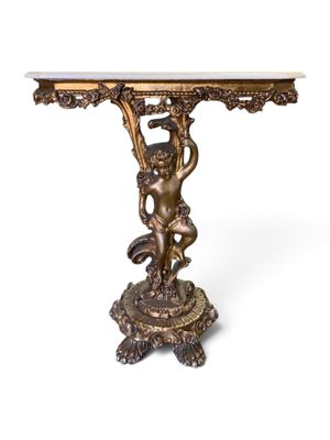 an antique bronze table with a cupid on it and a marble top