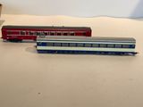two toy trains sitting on a table next to each other