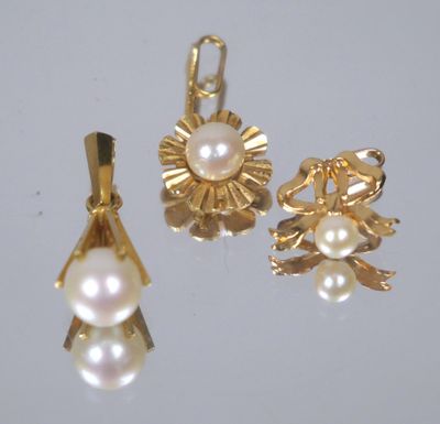 two gold and pearl pendants and a pair of earrings