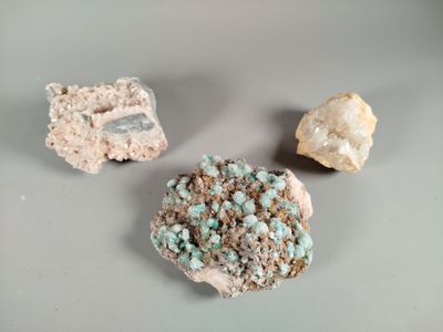 three different types of rocks on a table with a gray background
