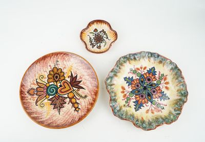 three plates with different designs on them on a table