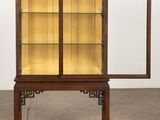 an antique display cabinet with glass doors and a wooden base