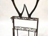 a metal rack with a deer ' s antlers on it