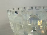 a glass bowl with ice cubes inside of it