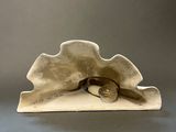 an image of a sculpture of a shell with a pair of glasses on it