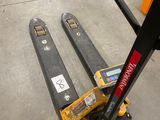 a fork lifter that is sitting on the floor in a warehouse