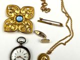 a gold pocket watch, a brooch, a pin, and a gold chain