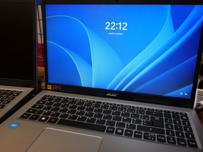 two laptops sitting side by side on a table