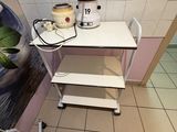 a small table with a mixer on it in a room