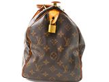 a close up of a brown louis vuitton handbag on a white background