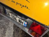 a yellow truck with a sticker on the back of it
