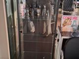 a glass display case in the middle of a room