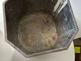 a metal bowl sitting on top of a white table