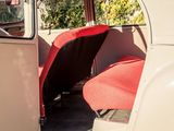 a red seat in the back of a white car