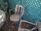 a dirty chair and a table in the yard