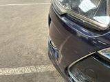 a close up of a car ' s headlight on a parking lot
