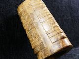 a close up of a wooden object on a black cloth