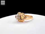 an image of a gold and diamond ring on a white plate