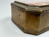 a gold box that is sitting on a white surface