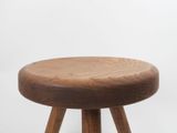 an image of a wooden stool with three legs on a white background