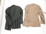 two jackets that are sitting on top of a white table