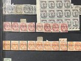 an old collection of stamps and stamps on display in a glass case