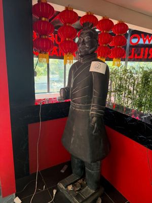 a statue of a man that is standing in front of a window