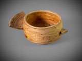 an image of a wooden bowl with a lid on a gray surface