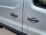 a silver van that is parked on the side of the road
