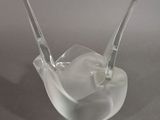 a clear glass bowl with a spoon sticking out of it
