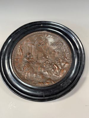 a close up of a metal plate with a picture of a man and woman on it