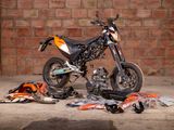 a motorcycle that is parked in front of a brick wall
