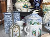 many plates and cups on a table with a lamp