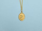 a woman wearing a gold necklace with a sun medallion on it