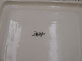 a close up of a white plate with a name on it