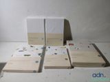 several books are lined up on a table with a white background