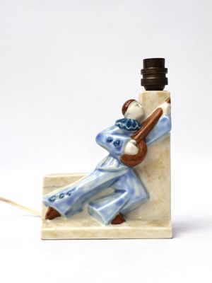 a figurine of a man playing a guitar on a table